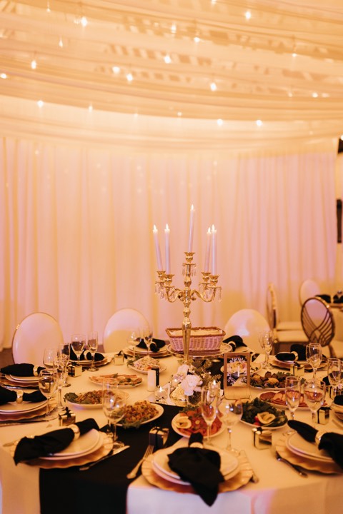 Table setting, gold candelabra, warm lights at our Orem, Utah event venue