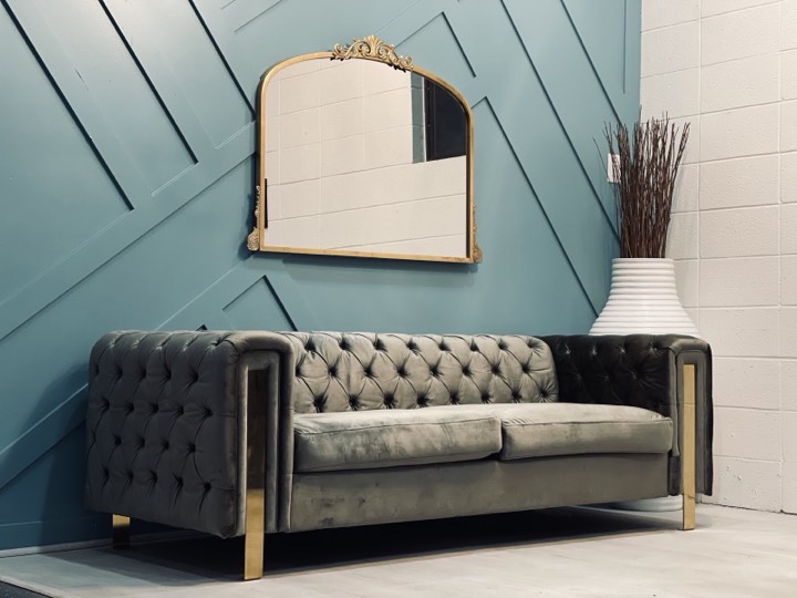 Velvet sofa and gold mirror on teal wall at our Utah Valley event venue in Orem