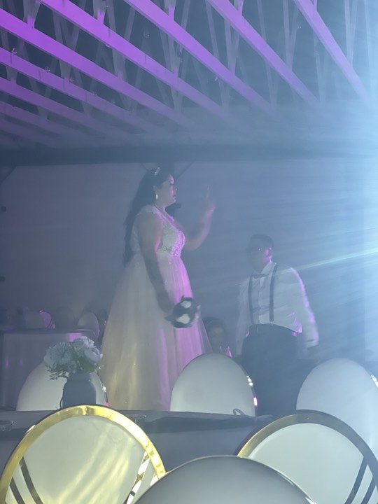 Bride on stage, purple lights at our Orem, Utah wedding and quinceañera venue
