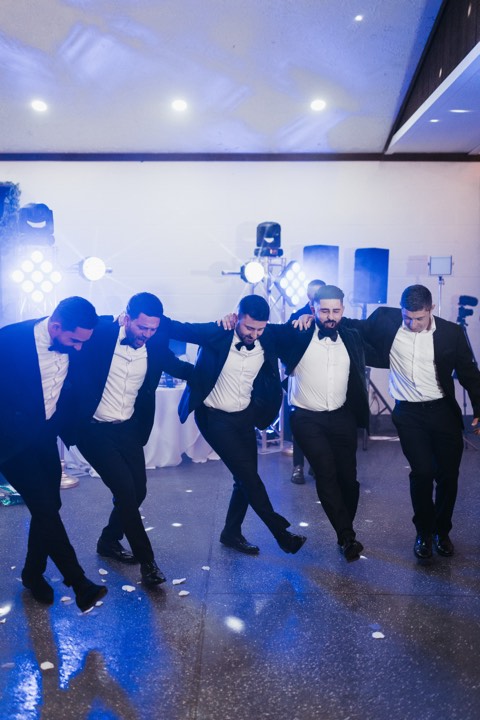 Groomsmen dance line, blue lights at our Utah Valley event venue in Orem