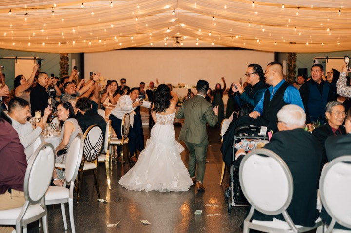 Newlyweds walk through cheering guests at our Orem, Utah wedding and quinceañera venue