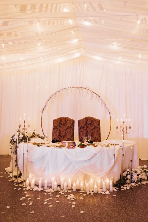 Sweetheart table with candles and arch at our Orem, Utah wedding and quinceañera venue