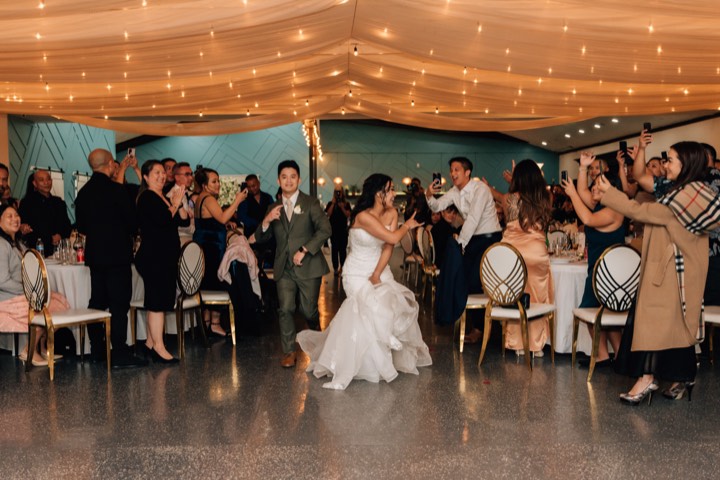 Wedding grand entrance, guests cheering at our Orem, Utah event venue