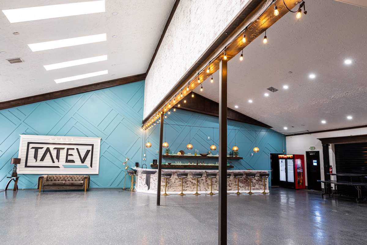 The main hall and bar with the blue accent wall at our Orem event venue